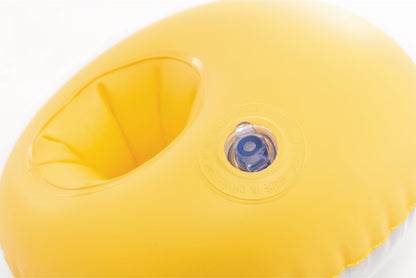 Inflatable arm ring with built-in valve on yellow surface