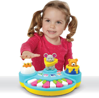 Child playing activity piano with three pop-up animal figures