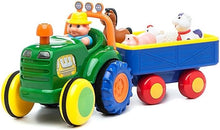 Motorized toy tractor with blue trailer, green cab, toddler driver and farm animal figures