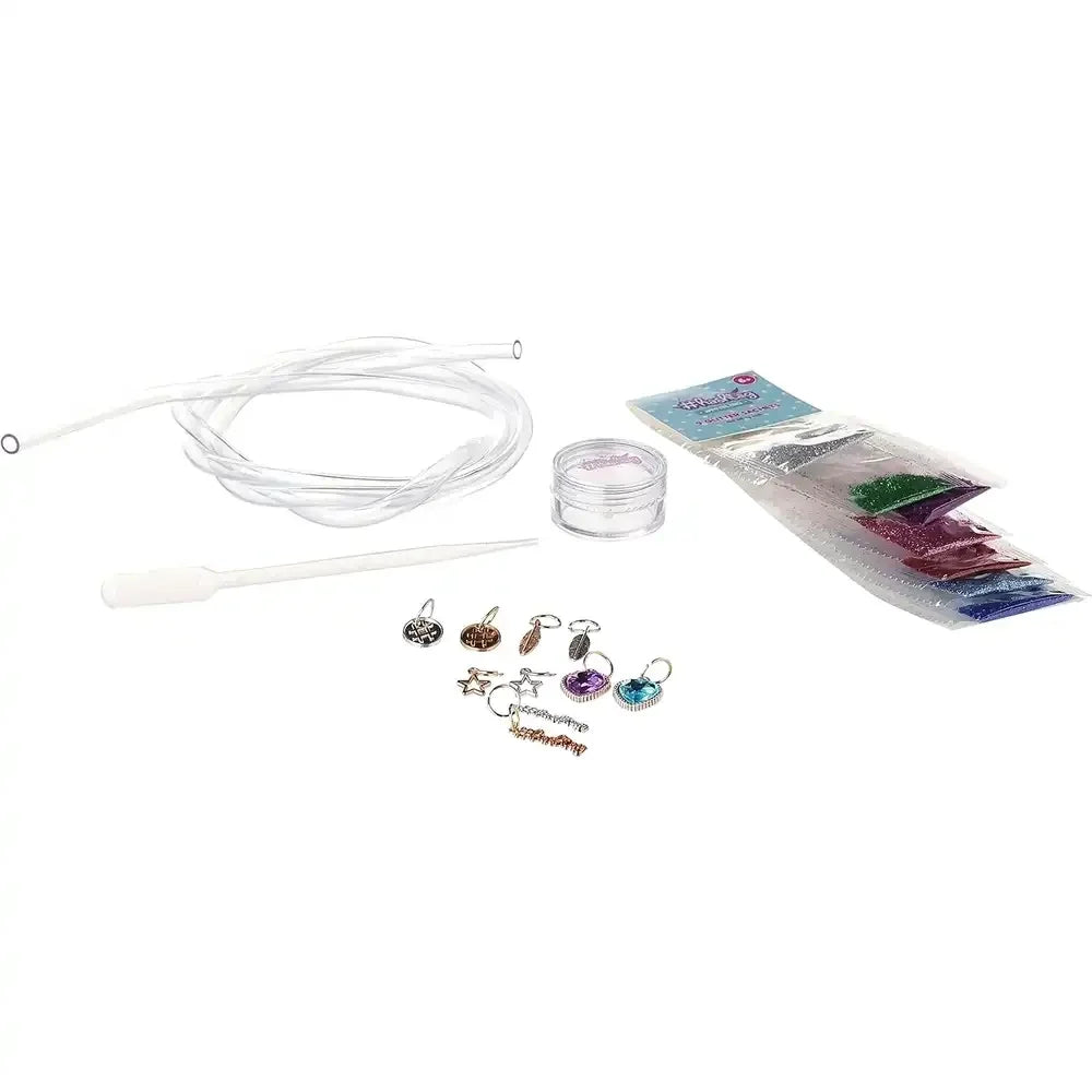 Water bracelet craft set contents with charms, beads, rings, and clear cord