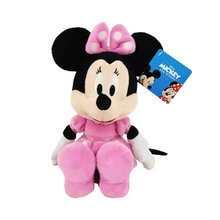 Plush Minnie Mouse doll in pink bow and dress, standing with fabric tag