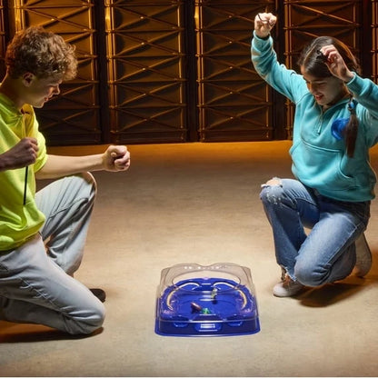 Blue Beyblade launcher case with beyblades on the floor for drop-attack play