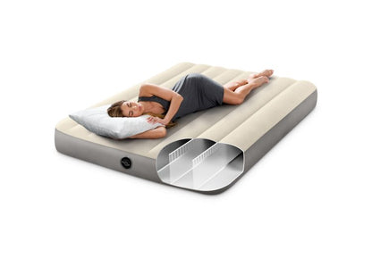 Single airbed with ribbed beige top and gray sides, valve visible; people resting