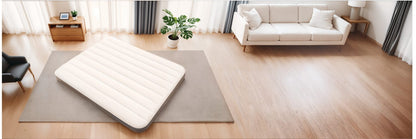 Single-high airbed in a living room, cream top and dark gray base
