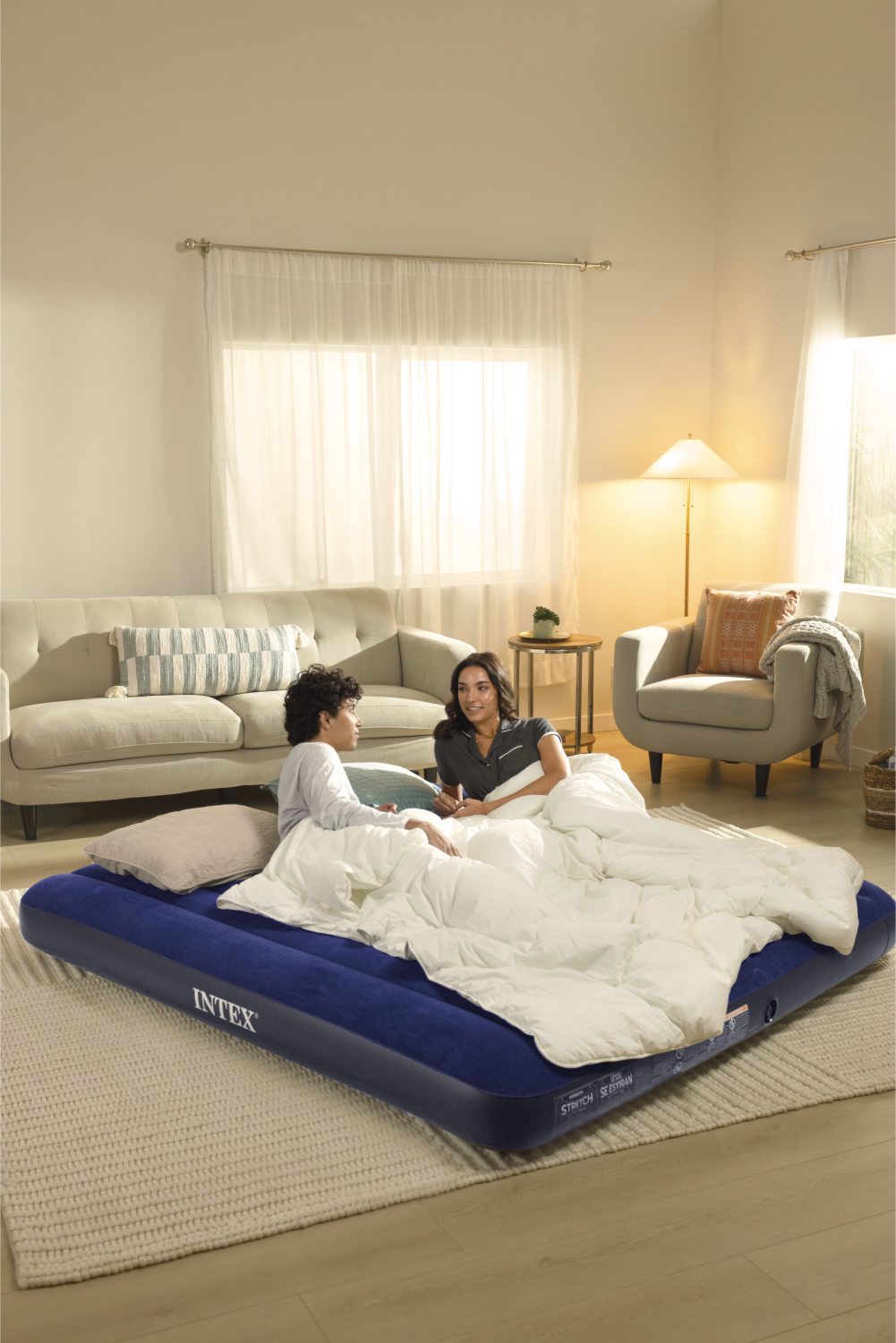 Intex king airbed, navy top with dark base under white bedding