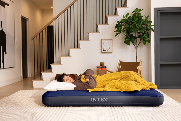 Dark blue INTEX airbed with ribbed top, with sleeper lying on it