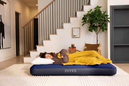 Dark blue INTEX airbed with ribbed top, with sleeper lying on it