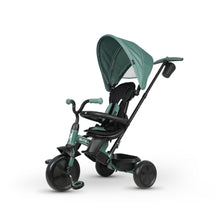 Green 3-wheel tricycle stroller with wide canopy and padded seat, front tray attached
