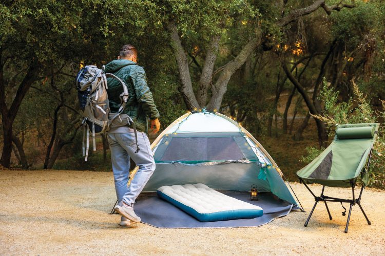 Camping mat inside tent, gray surface with blue border