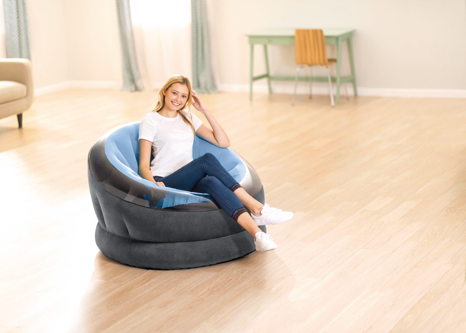 Large round beanbag chair with dark gray outer and light blue inner cushion