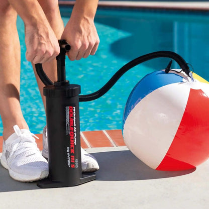 Hand air pump connected to an inflatable ball with hose and nozzle