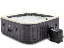 Inflatable outdoor hot tub spa with dark gray textured walls and white rim, side heater