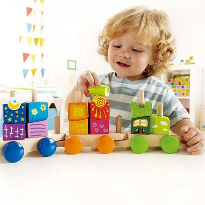 Child playing with colorful wooden activity train blocks on round wheels