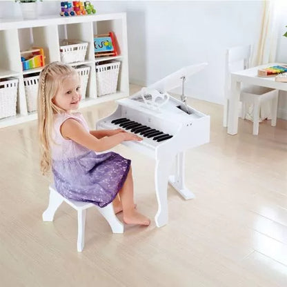 White grand piano keyboard with bench; child playing in purple dress