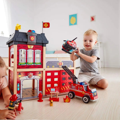 Fire station playset with red-and-grey buildings, open doors, and fire truck