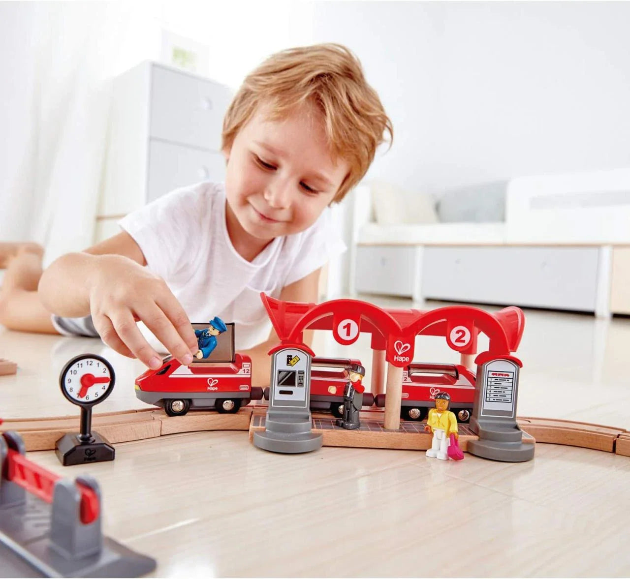 Red double tunnel station pieces with numbers 1 and 2, plus toy train cars