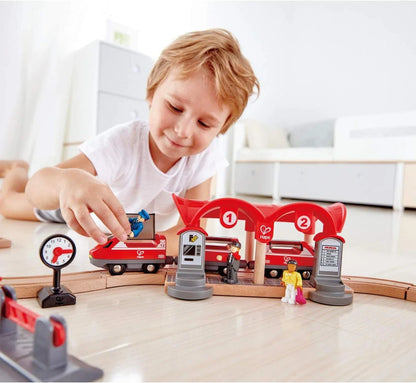 Red double tunnel station pieces with numbers 1 and 2, plus toy train cars
