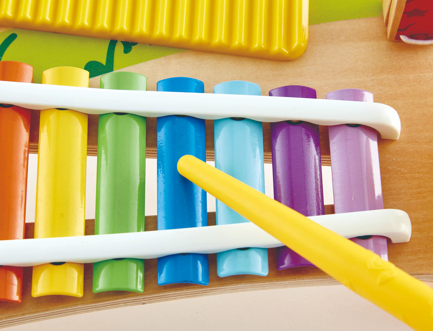 Close-up of colorful xylophone bars with a yellow mallet