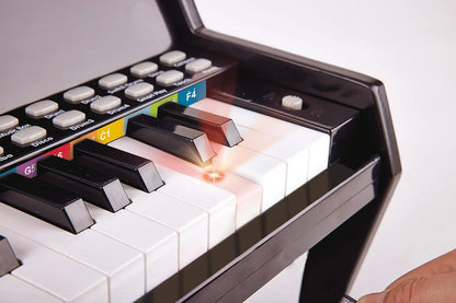 Toy keyboard close-up with white keys and colored label buttons on dark panel