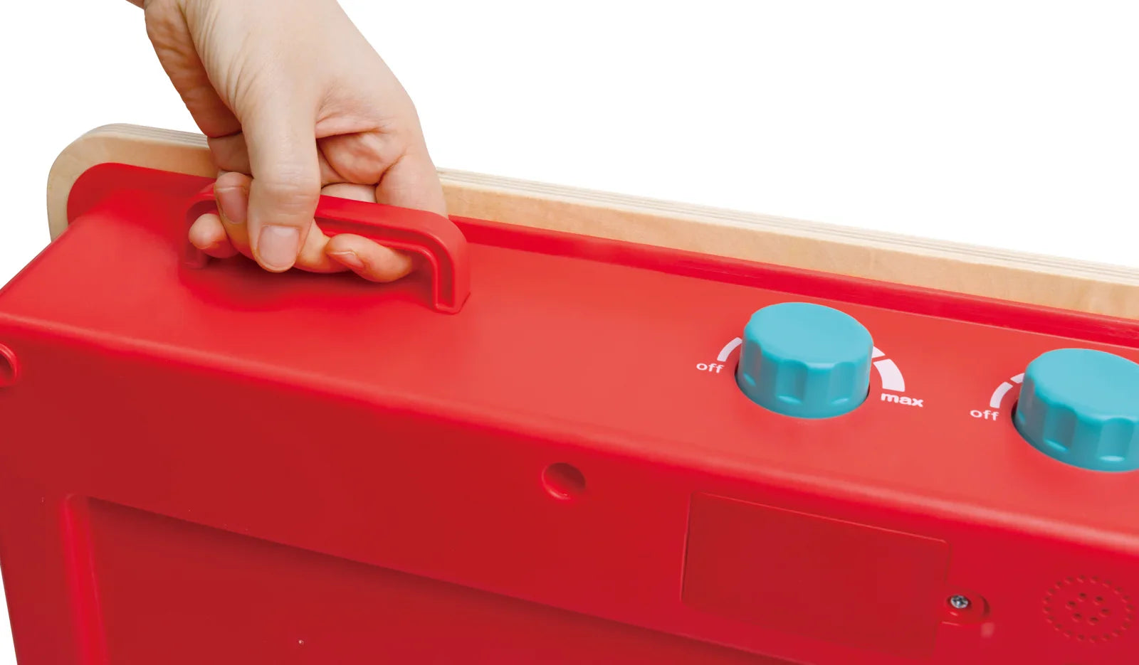 Hand adjusting play kitchen stove knobs on the red countertop unit