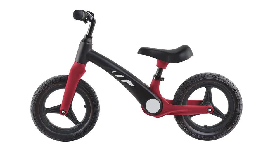 Red learner balance bike with black frame, handlebar and thick tread wheels