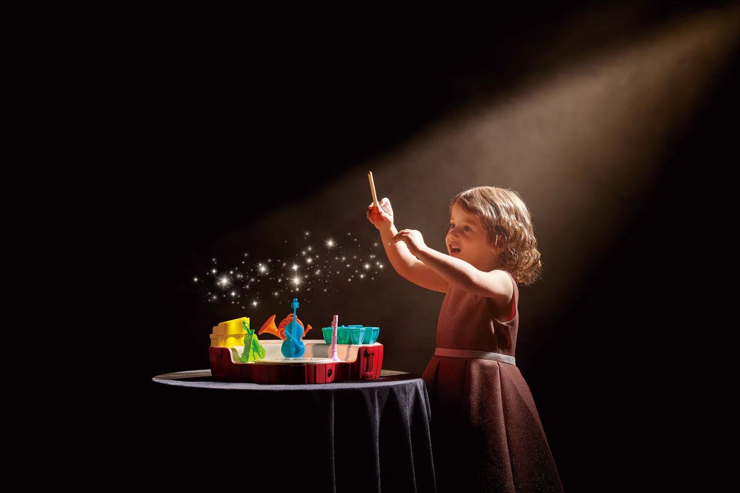 Mini conductor’s orchestra musical toy with colorful instrument pieces on tabletop