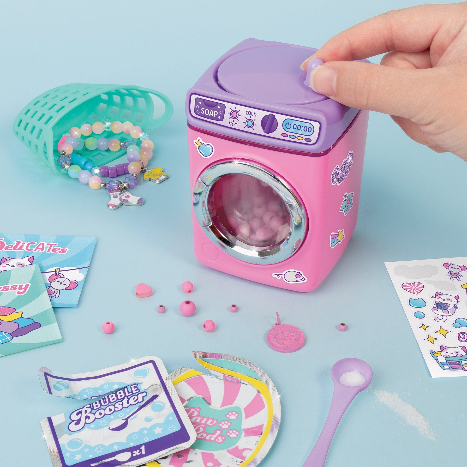 Purple and pink Wash ’N Bead bracelets machine with beads, soap pieces, and charm