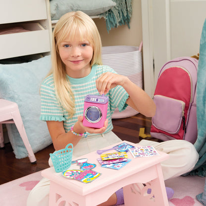 Kid holding a Wash ’N Bead bracelets machine with bracelet charms and bead accessories