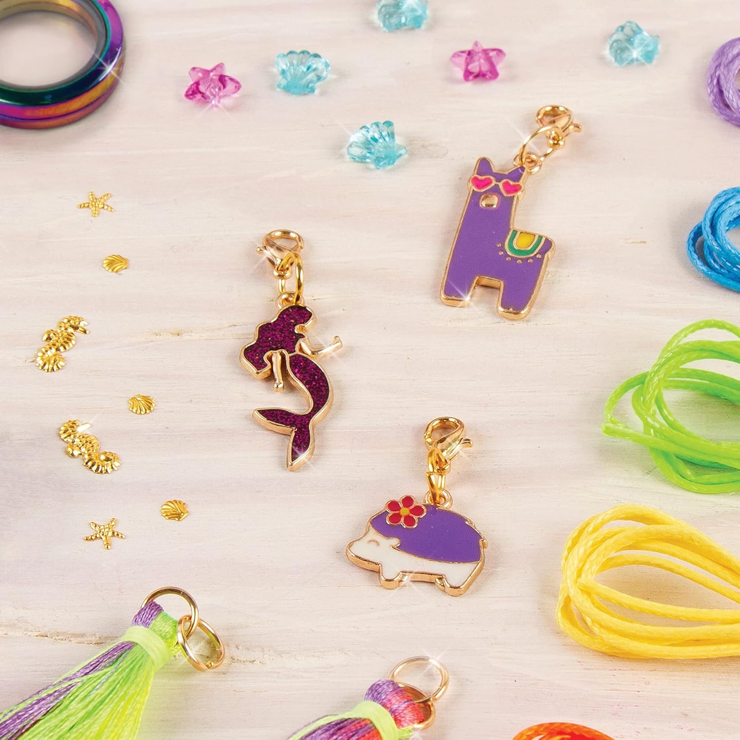 Gold-toned animal charm pendants with tassels and small bead decorations