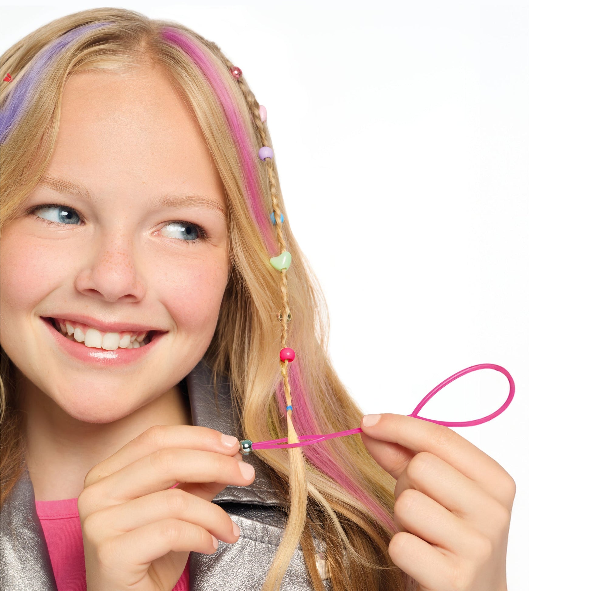 Child using pink hair-styling strands with bead accents and star hair clips