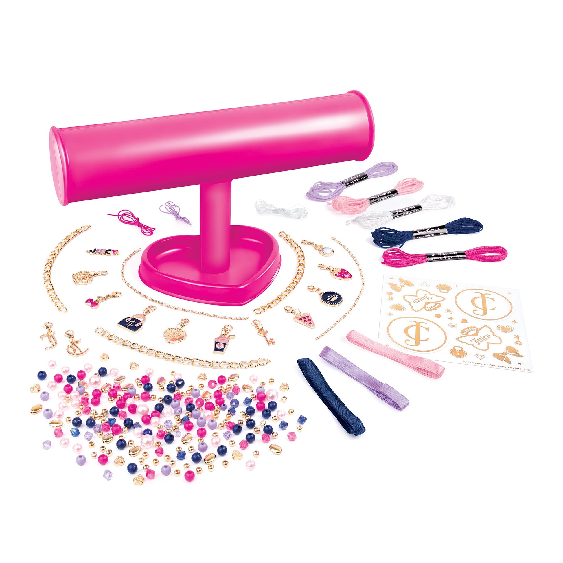 Pink bracelet-making kit contents: bead strands, charms, tools, and pink stand.