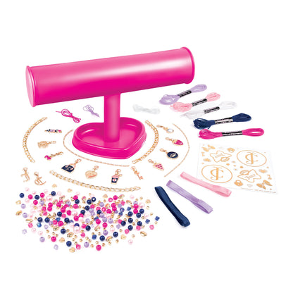 Pink bracelet-making kit contents: bead strands, charms, tools, and pink stand.