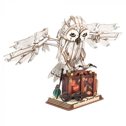 DIY wooden moving diorama of an owl with wing and suitcase carriage base