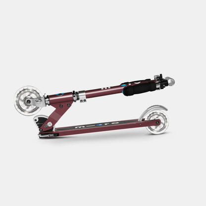 Sprite LED Autumn Red kick scooter, angled view, silver wheels and black handlebar grip