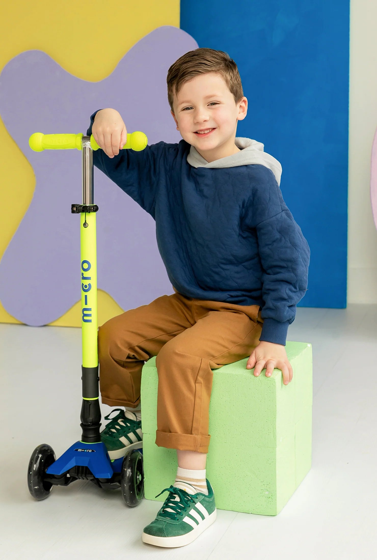 Foldable LED scooter with lime green stem and blue deck, three-wheel design