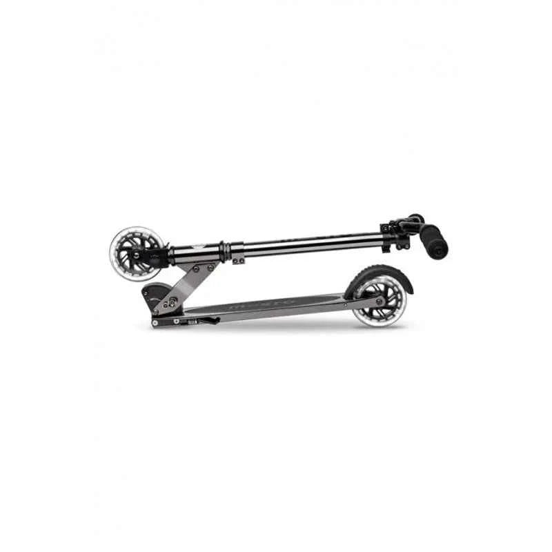 Black LED scooter side view with long frame, two wheels, and rear deck