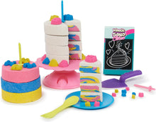 Kinetic Sand rainbow cake set with tiered cake, candle, tray, and colorful sand pieces