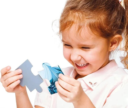 Child playing with blue puzzle pieces from a princess-themed jigsaw set
