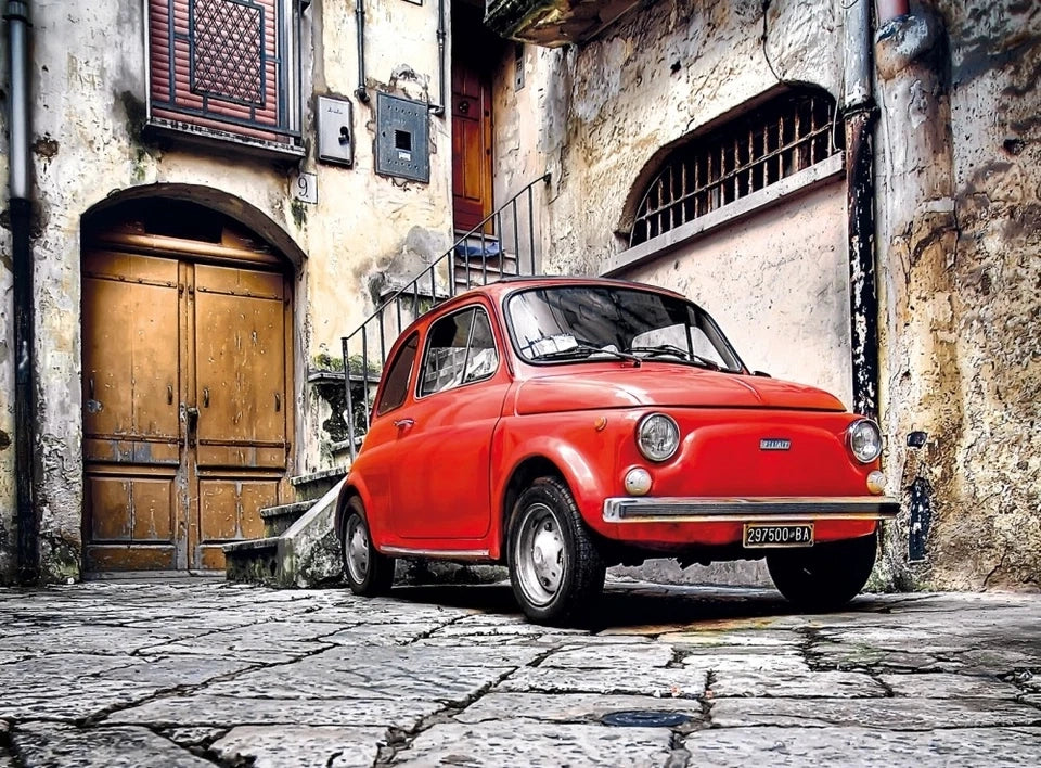 500-piece puzzle artwork of a red Fiat 500 parked on a cobblestone street