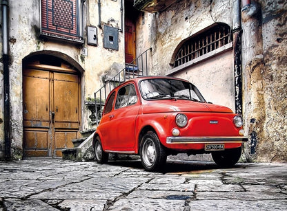500-piece puzzle artwork of a red Fiat 500 parked on a cobblestone street