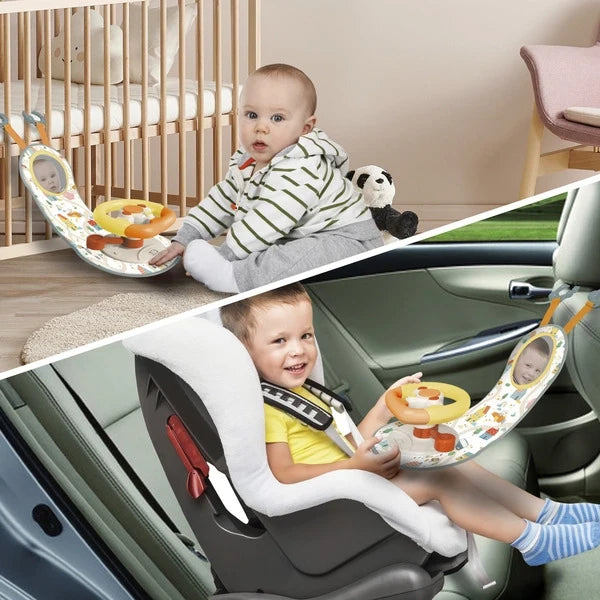 Interactive steering wheel activity toy with buttons and mirror, used by a baby in a seat