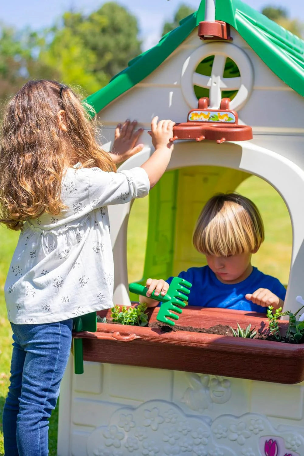 Children playing at front garden planter with toy plants on Feber Eco House