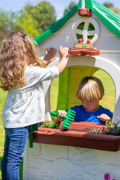 Children playing at front garden planter with toy plants on Feber Eco House