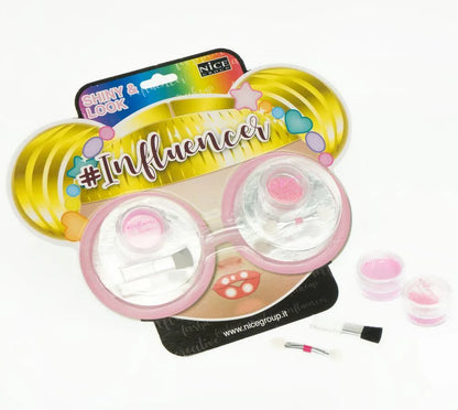 Influencer shiny look makeup compact with pink glitter jars, brushes, and sponges