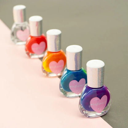 Rainbow manicure set nail polish bottles in red, orange, blue, and purple with hearts
