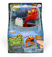 Red snap dragon toy in light blue bowl with white sound device, retail box front view