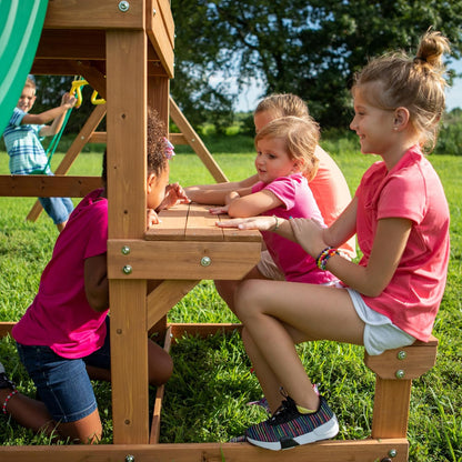 Wood climbing steps and platform on cedar playset with railing and green slide