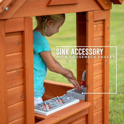 Side sink with gooseneck faucet on countertop inside cedar playhouse