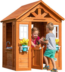 Cedarwood playhouse with gabled roof, front windows, and open doorway