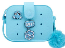 Light blue mini crossbody bag with animal patches, “BFF!” badge, and fuzzy pom-pom